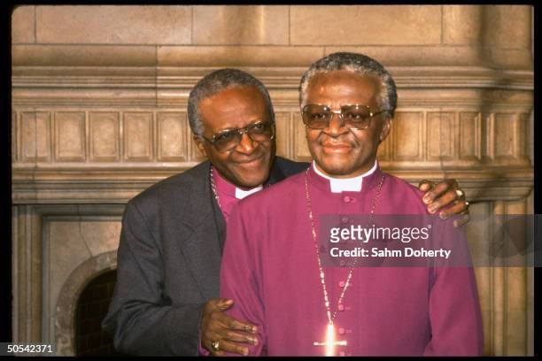 Archbishop Desmond Tutu standing beside life-like wax dummy of himself at Madame Tussaud's wax museum.