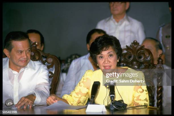 Philippine President Corazon Aquino with Vice President Salvador Laurel announcing abolition of the constitution and parliament and institution of a...