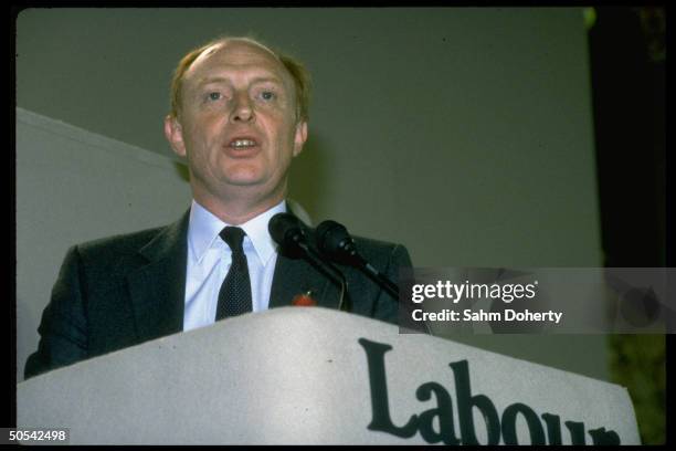 British Labor Party leater Neil Kinnock speaking while standing at podium during party conference.