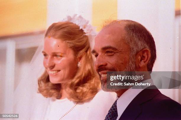 Jordan's King Hussein standing with new bride Lisa Halaby at the royal palace.