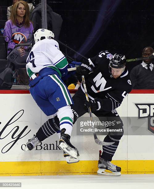 Emerson Etem of the Vancouver Canucks and Calvin de Haan of the New York Islanders collide during the third period at the Barclays Center on January...