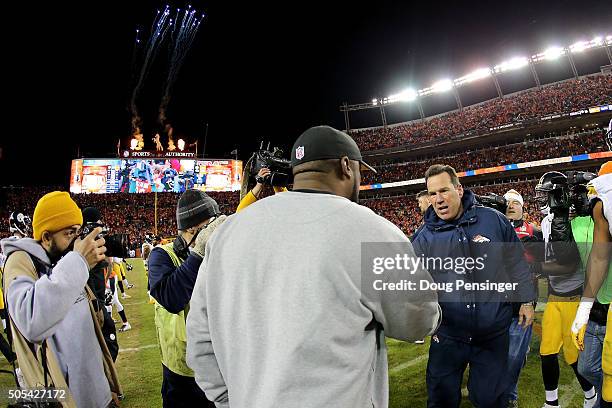 Head coach Gary Kubiak of the Denver Broncos and head coach Mike Tomlin of the Pittsburgh Steelers meet on the field after the AFC Divisional Playoff...