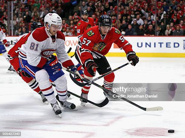 Lars Eller of the Montreal Canadiens chases down the puck with Dennis Rasmussen and Trevor van Riemsdyk of the Chicago Blackhawks at the United...