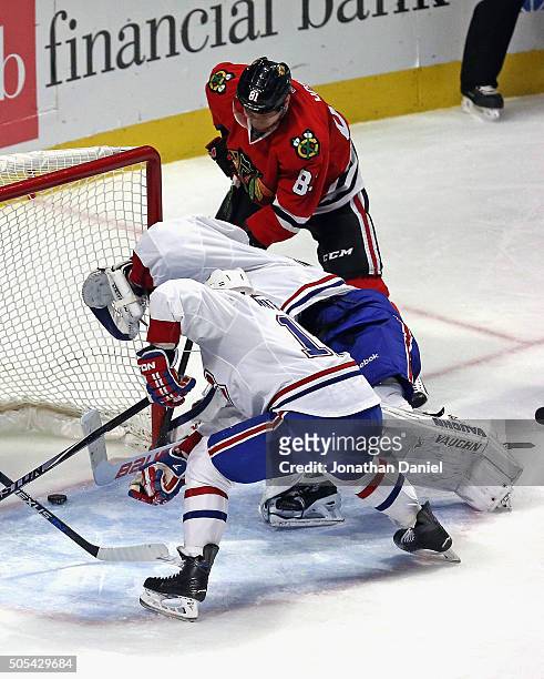 Marian Hossa of the Chicago Blackhawks scores a goal in the second period against Ben Scrivens and Torrey Mitchell of the Montreal Canadiens at the...