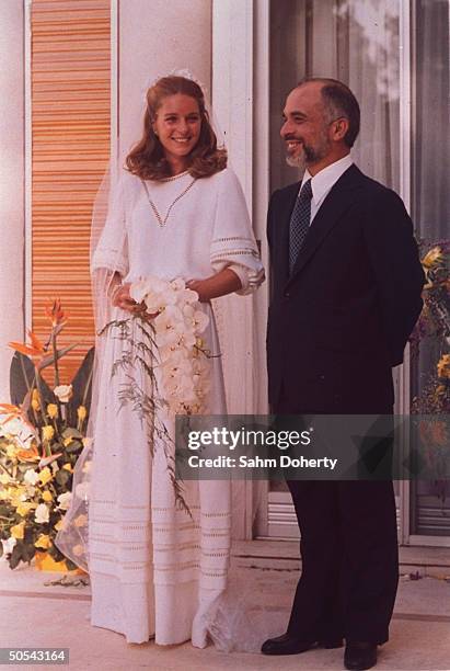 Jordan's King Hussein standing with new bride Lisa Halaby at the royal palace.