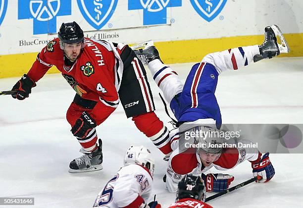 Jeff Petry of the Montreal Canadiens falls over the back of Niklas Hjalmarsson of the Chicago Blackhawks at the United Center on January 17, 2016 in...