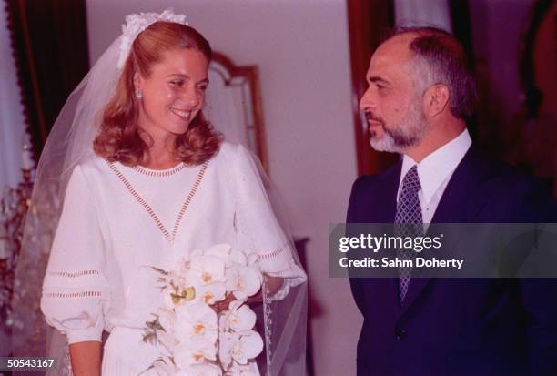 Jordan's King Hussein standing with new bride Lisa Halaby at the royal palace.