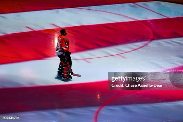 Goalie Corey Crawford of the Chicago Blackhawks stands on the ice during the national anthem prior to the start of the NHL game against the Montreal...