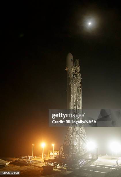 In this handout provided by the National Aeronautics and Space Administration, the moon is seen behind the SpaceX Falcon 9 rocket with the Jason-3...