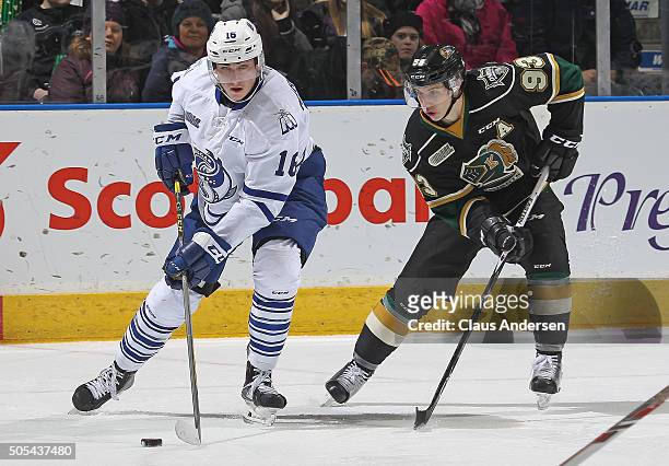 Mason Marchment of the Mississauga Steelheads is checked closely by Mitchell Marner of the London Knights during an OHL game at Budweiser Gardens on...