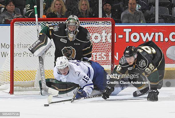 Mason Marchment of the Mississauga Steelheads takes a goalie interference penalty by sliding into Tyler Parsons of the London Knights during an OHL...