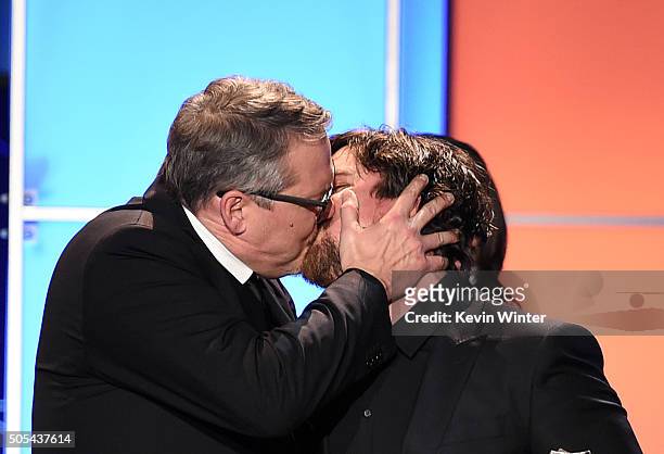 Director Adam McKay and actor Christian Bale kiss onstage as they accept the Best Comedy award for 'The Big Short' during the 21st Annual Critics'...
