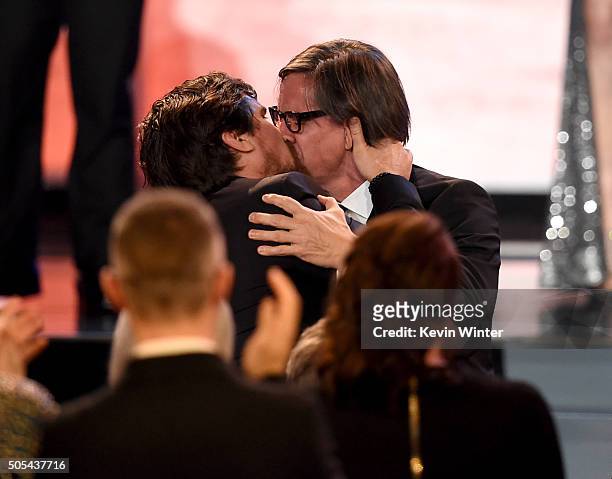 Actor Christian Bale and screenwriter Charles Randolph kiss onstage as they accept the Best Comedy award for 'The Big Short' during the 21st Annual...