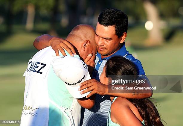 Fabian Gomez of Argentina celebrates with his caddie after winning during a playoff in the final round of the Sony Open In Hawaii at Waialae Country...