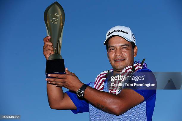 Fabian Gomez of Argentina celebrates with the winner's trophy after defeating Brandt Snedeker during a playoff during the final round of the Sony...