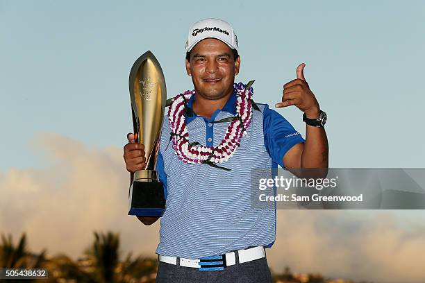 Fabian Gomez of Argentina celebrates with the winner's trophy after defeating Brandt Snedeker during a playoff during the final round of the Sony...