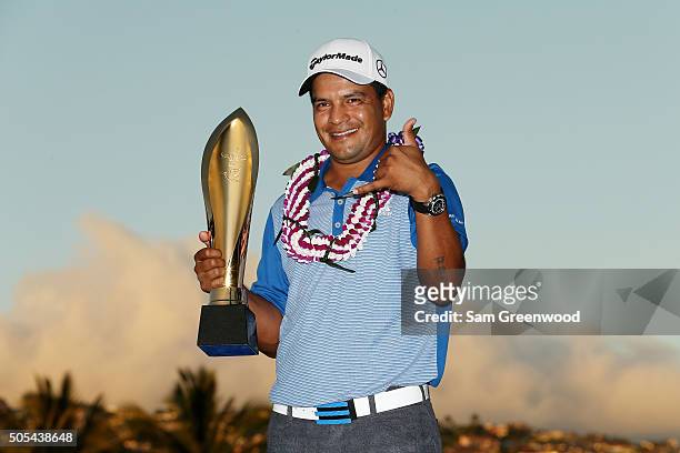 Fabian Gomez of Argentina celebrates with the winner's trophy after defeating Brandt Snedeker during a playoff during the final round of the Sony...