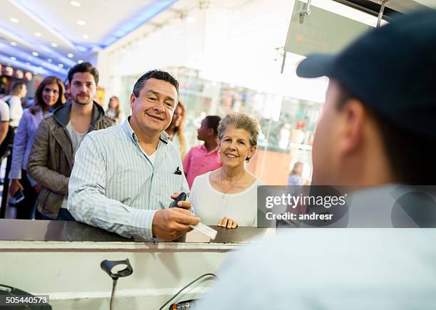 couple buying tickets at the movies - movie counter stock pictures, royalty-free photos & images