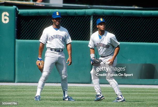 Outfielder Ken Griffey Jr and his father Ken Griffey Sr of the Seattle Mariners stands together in the outfield during batting practice prior to the...