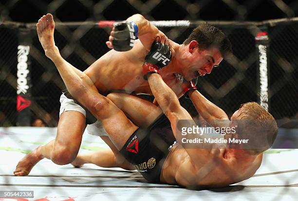 Dominick Cruz grapples with T.J. Dillashaw in their bantamweight bout during UFC Fight Night 81 at TD Banknorth Garden on January 17, 2016 in Boston,...