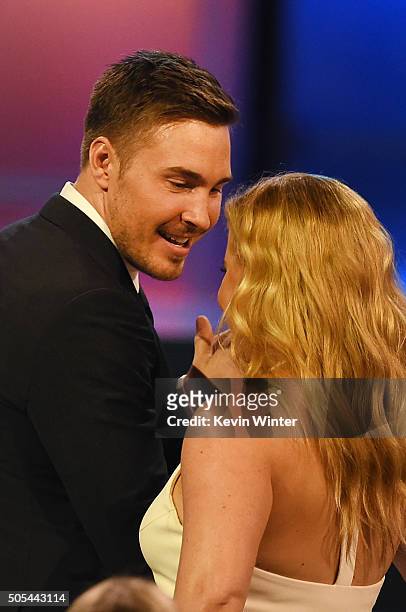 Ben Hanisch and actress/comedian Amy Schumer in the audience onstage during the 21st Annual Critics' Choice Awards at Barker Hangar on January 17,...