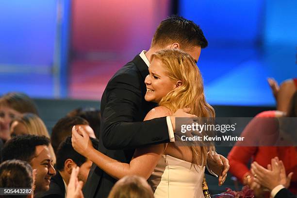 Actress Amy Schumer wins Best Actress in a Comedy for 'Trainwreck' with Ben Hanisch during the 21st Annual Critics' Choice Awards at Barker Hangar on...