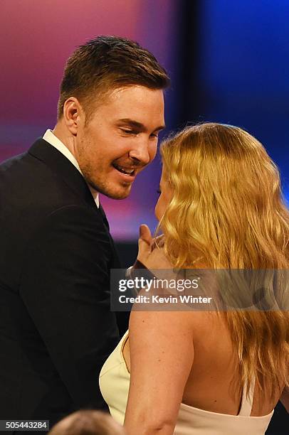 Actress Amy Schumer wins Best Actress in a Comedy for 'Trainwreck' with Ben Hanisch during the 21st Annual Critics' Choice Awards at Barker Hangar on...