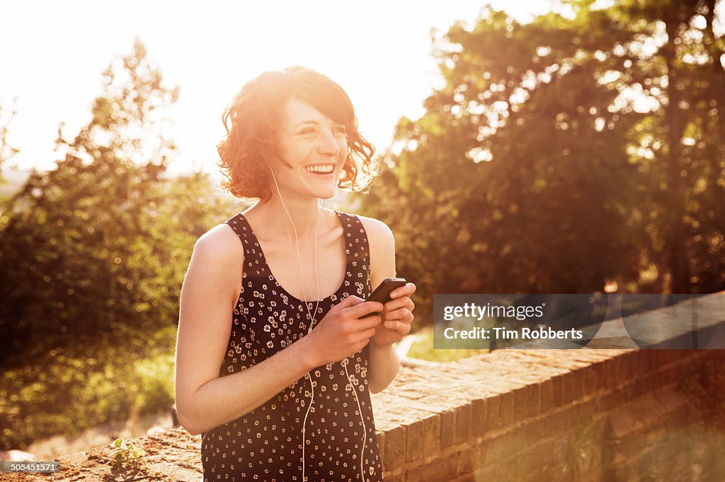 Woman with smartphone and headphones.