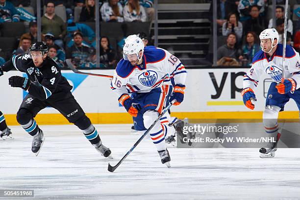 Teddy Purcell of the Edmonton Oilers skates after the puck against Brenden Dillon of the San Jose Sharks at SAP Center on January 14, 2016 in San...