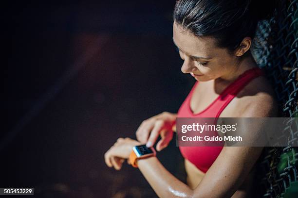 woman checking pulse. - reloj inteligente fotografías e imágenes de stock