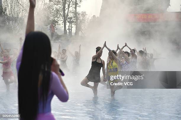 Yoga fans practice in a hot spring on January 17, 2016 in Luoyang, Henan Province of China. Nearly a hundred yoga fans performed yoga in a hot spring...