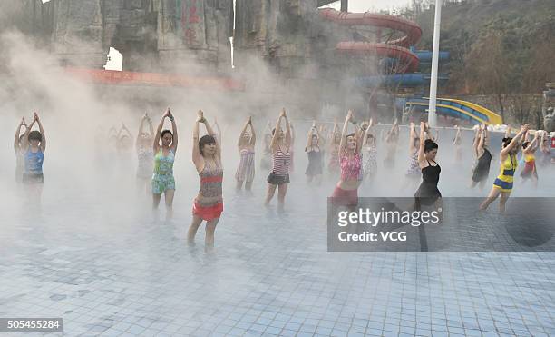 Yoga fans practice in a hot spring on January 17, 2016 in Luoyang, Henan Province of China. Nearly a hundred yoga fans performed yoga in a hot spring...