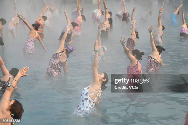 Yoga fans practice in a hot spring on January 17, 2016 in Luoyang, Henan Province of China. Nearly a hundred yoga fans performed yoga in a hot spring...