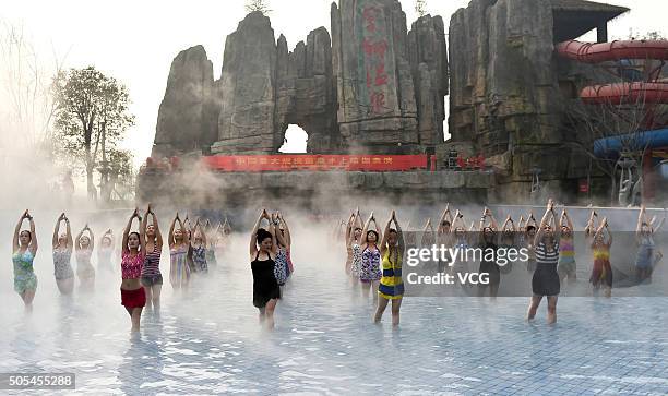 Yoga fans practice in a hot spring on January 17, 2016 in Luoyang, Henan Province of China. Nearly a hundred yoga fans performed yoga in a hot spring...