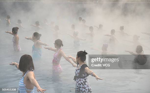 Yoga fans practice in a hot spring on January 17, 2016 in Luoyang, Henan Province of China. Nearly a hundred yoga fans performed yoga in a hot spring...