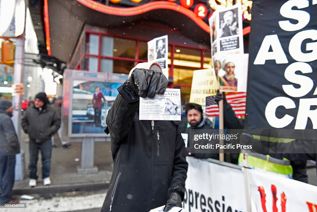 Holding out leaflet to passersby. Hundreds of Muslims...