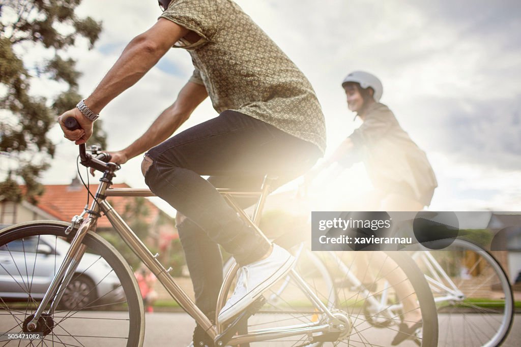 Australian mid adult couple riding bikes back home