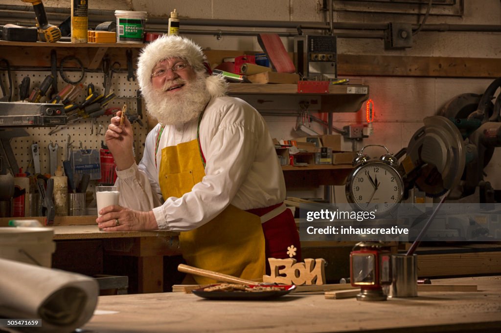 Santa Claus taking a break from working in his workshop