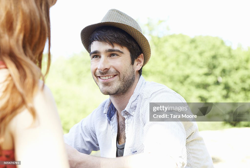 Man talking to woman in park