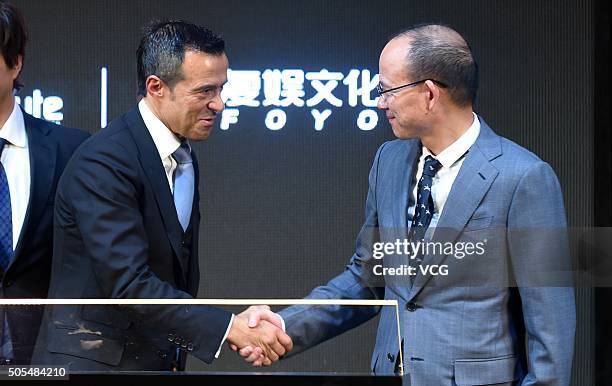 Portuguese football agent Jorge Mendes shakes hands with Guo Guangchang, Chairman of Fosun Group, during Gestifute and FOYO strategic partnership...