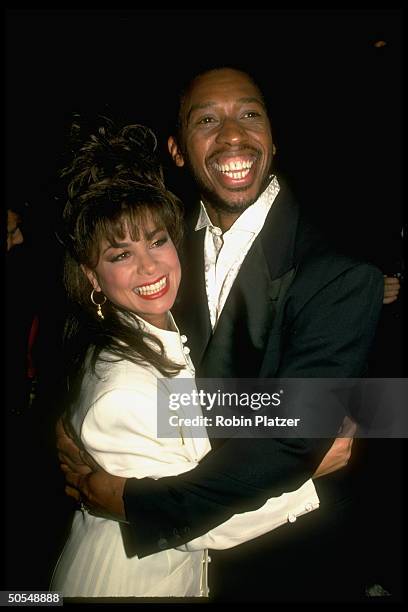 Singer Paula Abdul embracing singer Jeffrey Osborne.