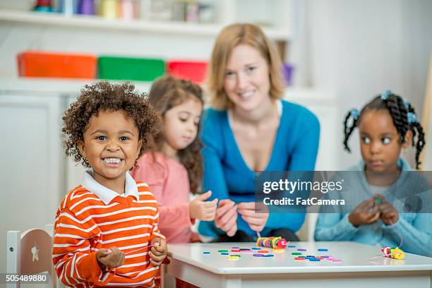 stringing beads in class - bead string stock pictures, royalty-free photos & images