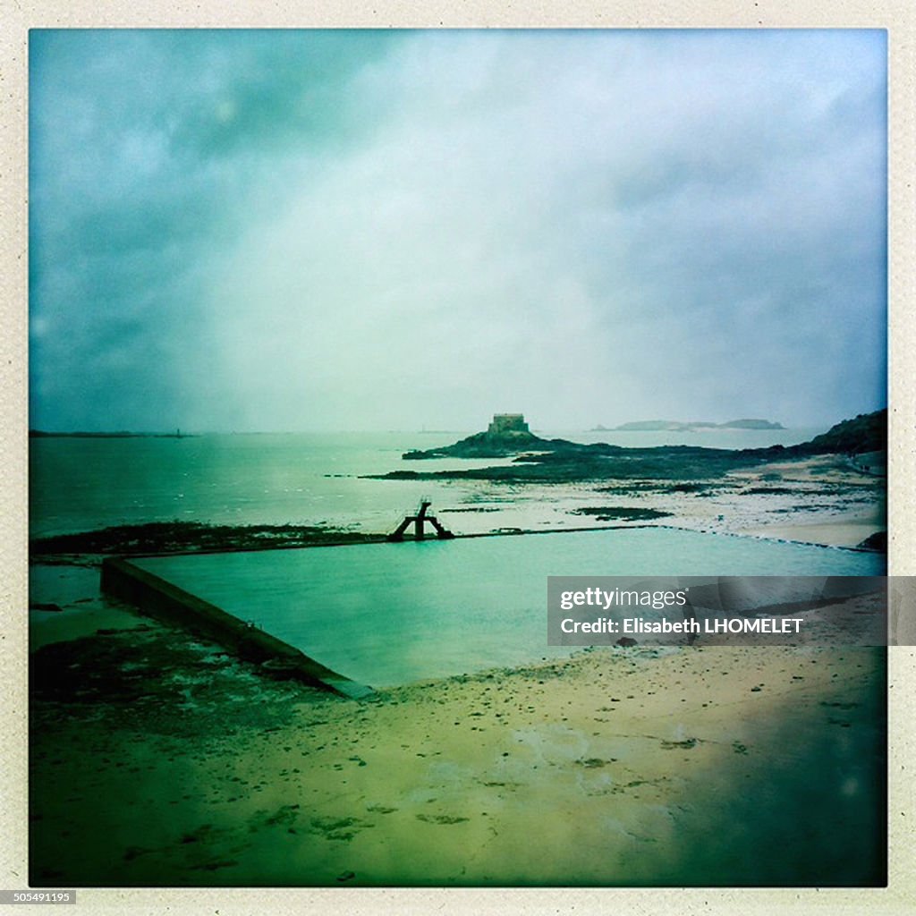 French cloudy beach with a sea pool at St-Malo