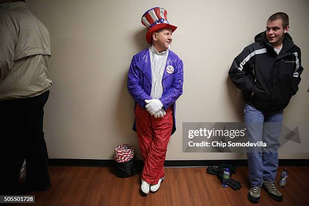 Wearing his homemade sequined Uncle Sam outfit, Tim Beverly of Amherst, VA, waits in line to see Republican presidential candidate Donald Trump...