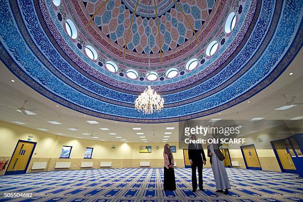 British Prime Minister David Cameron talks with Imam Qari Asim , and Shabana Muneer, a member of Makkah Masjid mosque's women's group, as he visits...