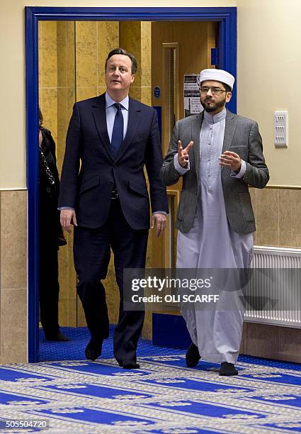 British Prime Minister David Cameron talks with Imam Qari Asim as he visits Makkah Masjid Mosque in Leeds, northern England, on January 18, 2016....