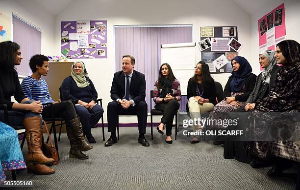 British Prime Minister David Cameron , speaks with women attending an English language class during a visit to the Shantona Women's Centre in Leeds,...