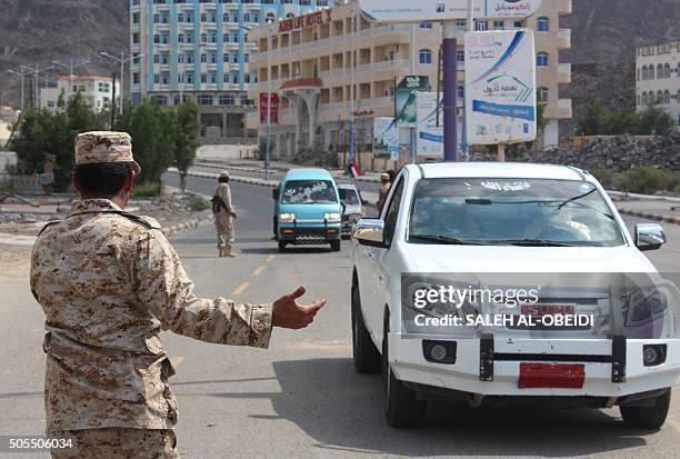 Security forces, loyal to Yemen's President, man a checkpoint in the southern city of Aden on January 18 a day after a suicide bombing targeted...