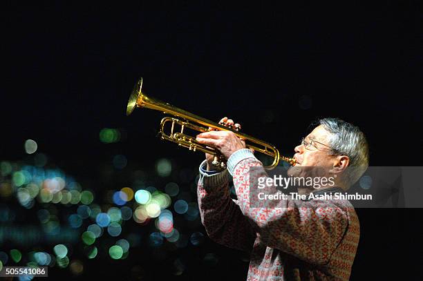 Man plays trumpet in commemoration of the victims as Japan marks the 21st anniversary of the Great Hanshin Earthquake on January 17, 2016 in...