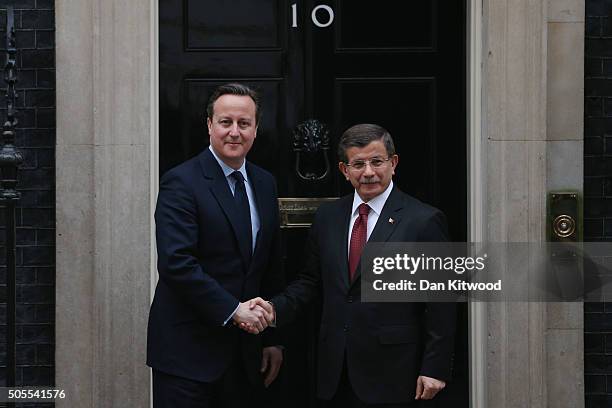 Turkish Prime Minister Ahmet Davutoglu is greeted by British Prime Minister David Cameron at 10 Downing Street on January 18, 2016 in London,...